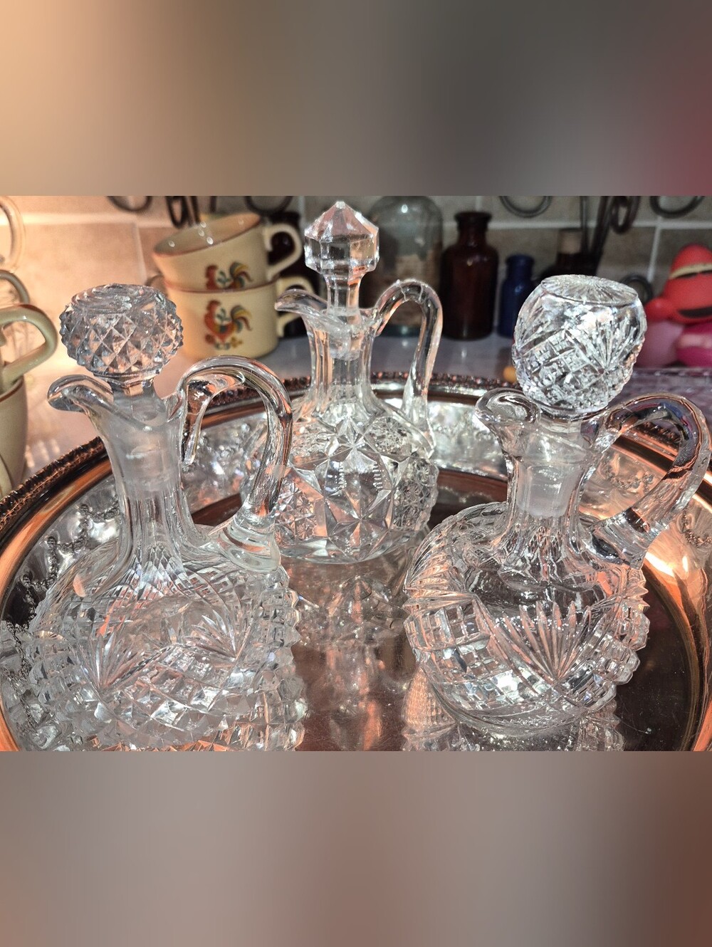 3 Vintage or Antique cut-glass cruets with matching stoppers and handles